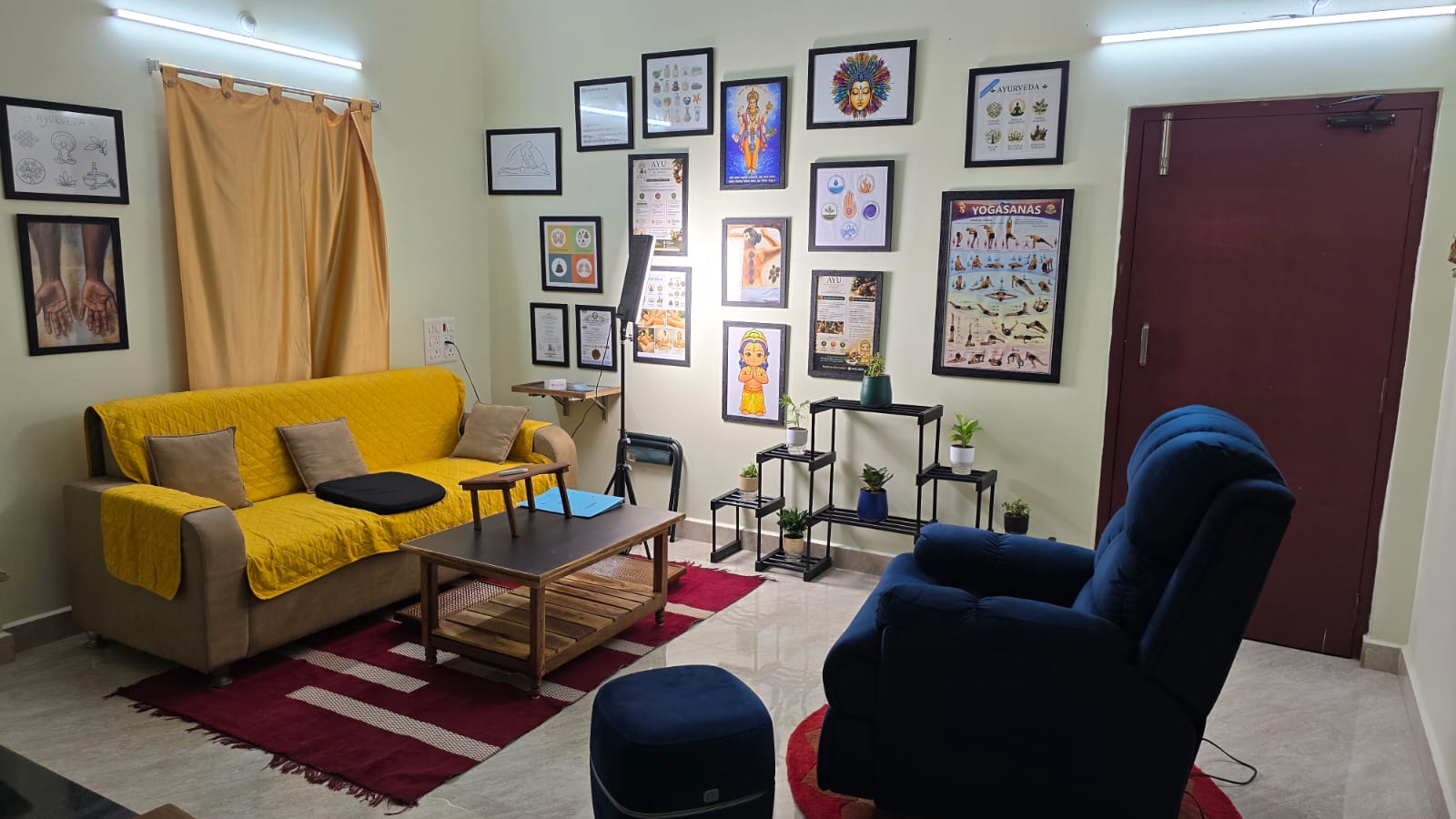 The AYU relaxation lounge — seating, plants and Ayurvedic wall art